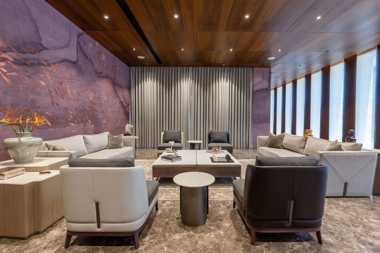 A living room with an onyx feature wall and full-height windows