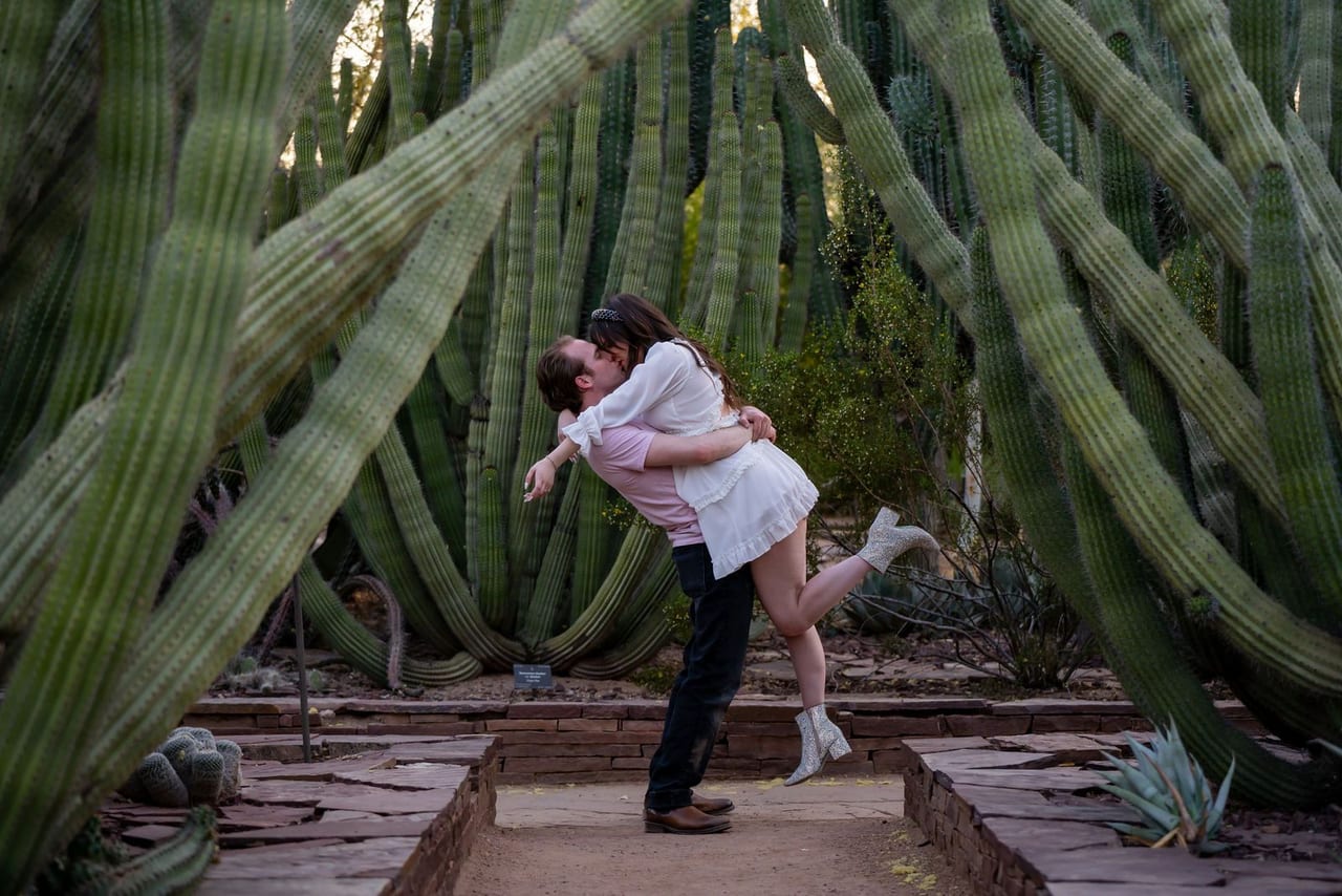 A man lifting his partner among tall columnar cacti