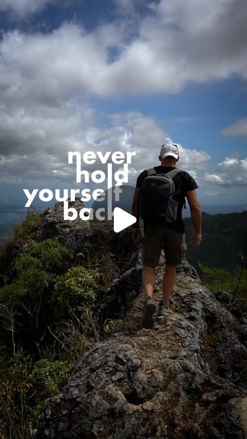 Rish Saini walking along a rocky ridge under a blue sky, a pack on his back