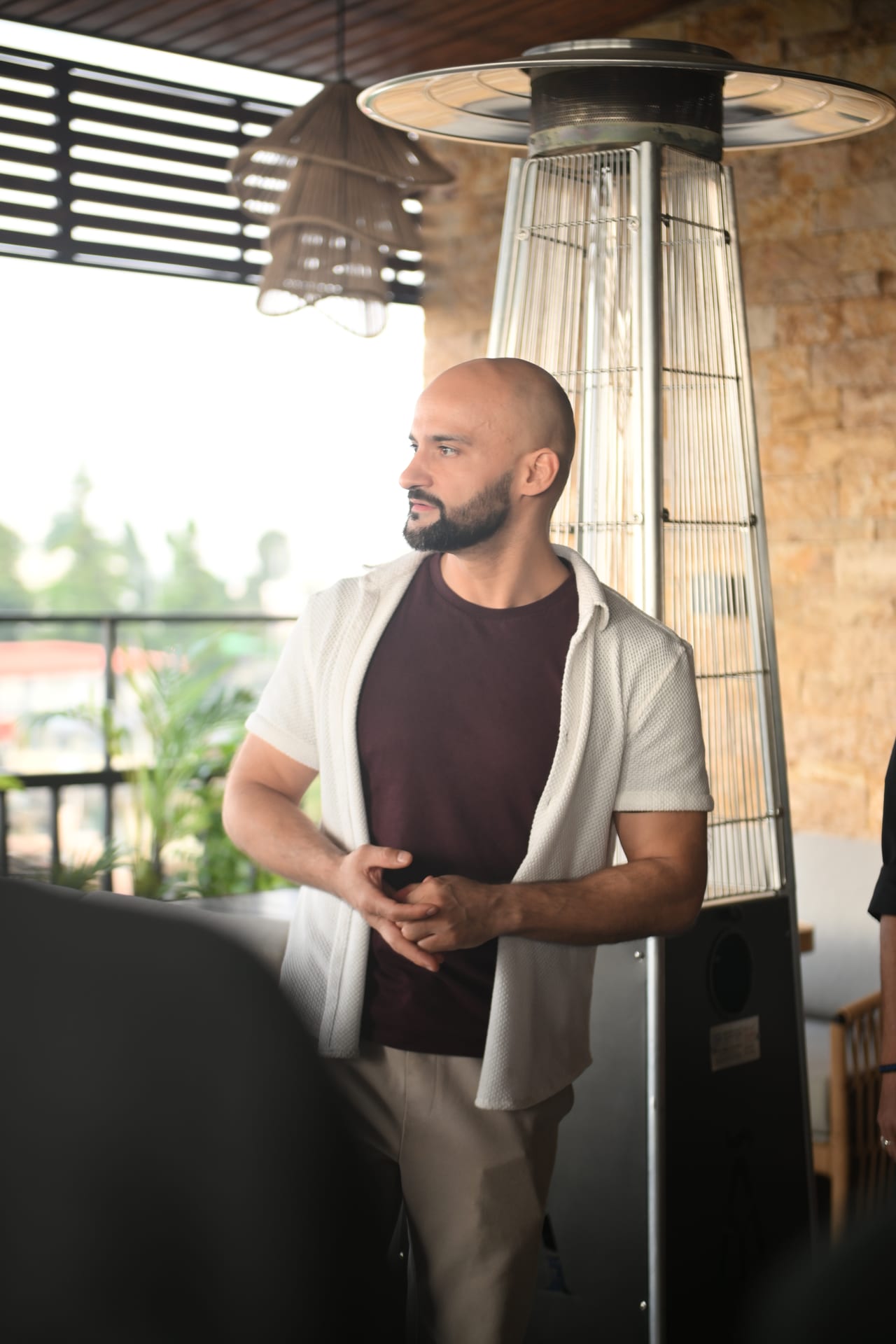 Rish Saini on the terrace at Ālaya Café & Bar, Shillong, in a white overshirt