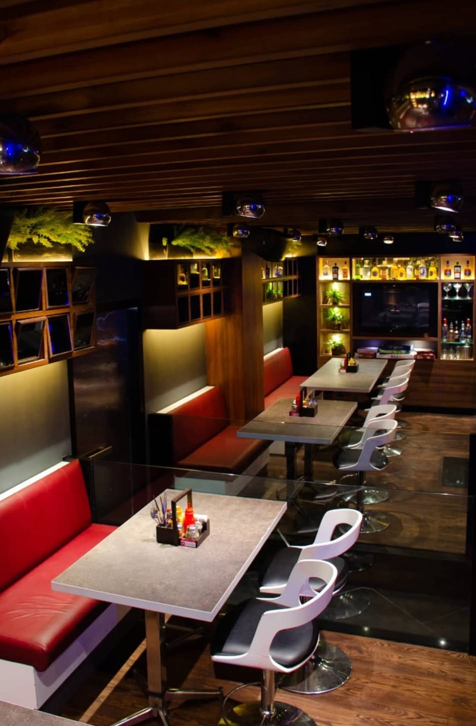 Red booths along a timber wall at Underdoggs Jalandhar